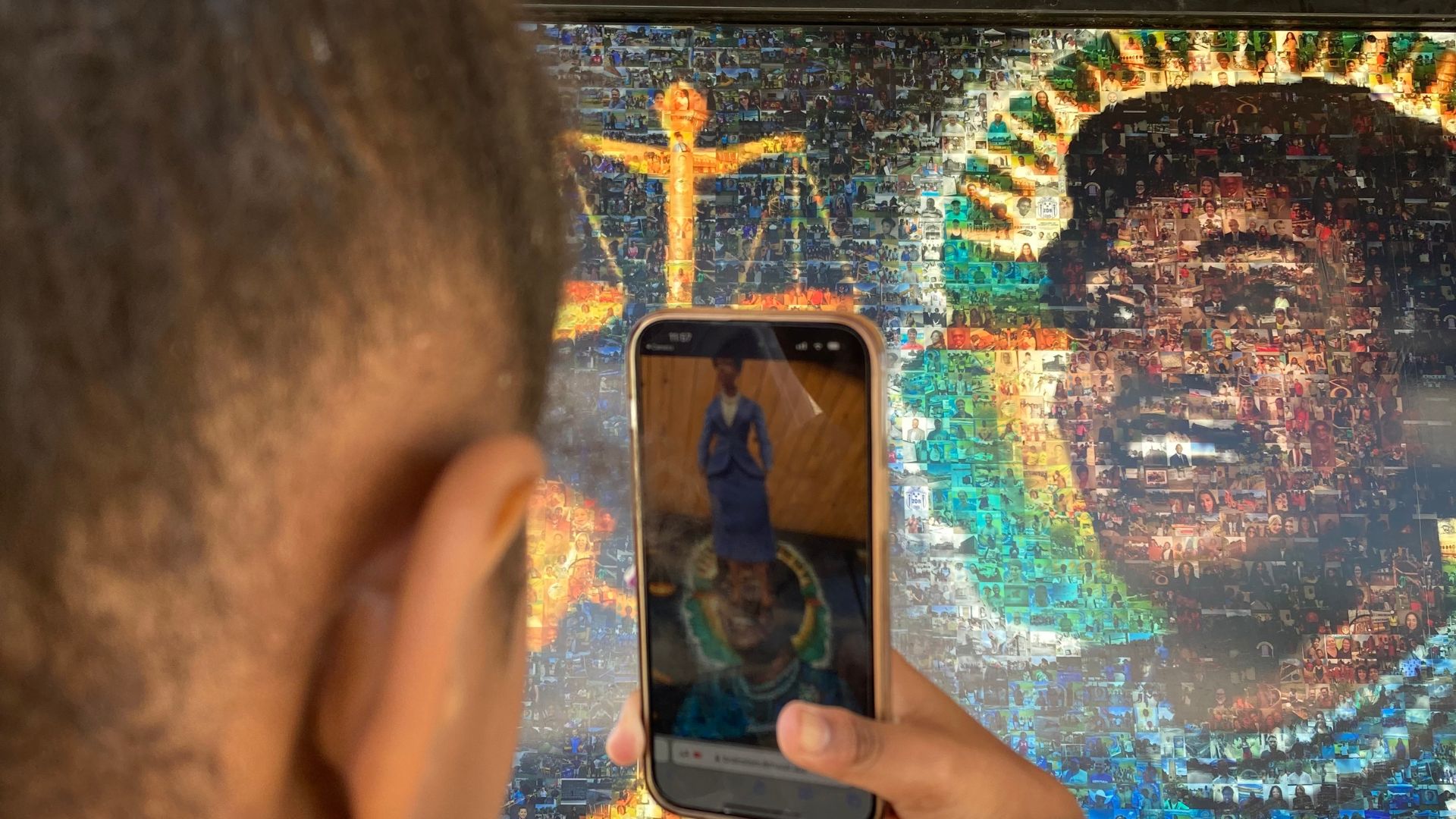 Girl using smartphone to scan a mural of Alberta O. Jones