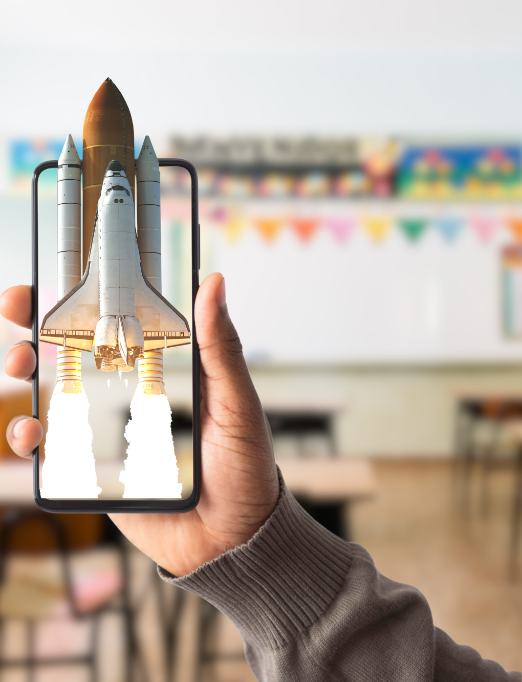 hand holding an iphone to view an augmented reality experience of a rocket launch in a classroom